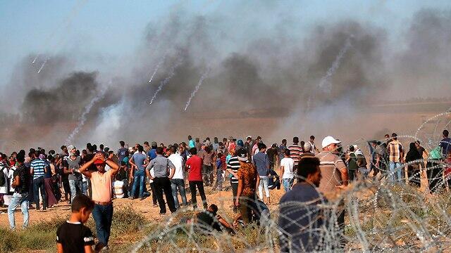 Palestinians at the Gaza border fence (צילום: AFP) Palestinians at the Gaza border fence