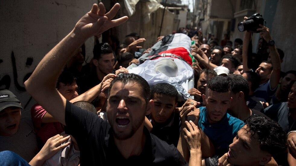 Palestinian mourners carry the body of 11 year-old Majdi al-Satari
