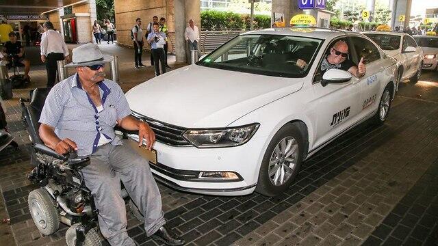 A disabled protester blocking a taxi