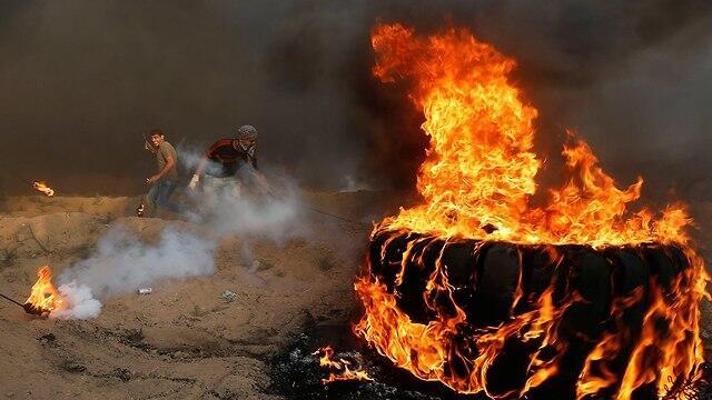 Palestinians burning tires during Gaza border protests