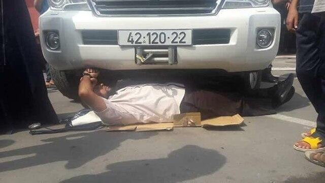 Protester lying underneath Schmale's car