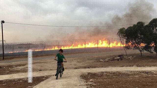 Yonatan Regev pedaling away from the fire