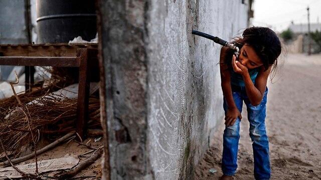 File Photo: Palestinian girl drinking water in Gaza   