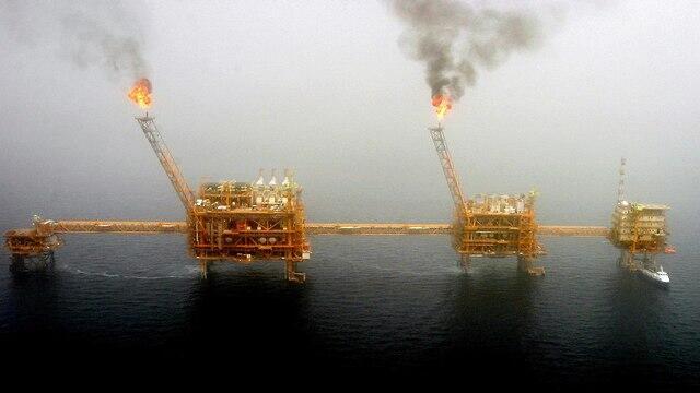 Gas flares from an oil production platform at the Soroush oil fields in the Persian Gulf, south of the capital Tehran, July 25, 2005
