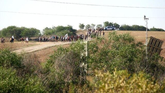 High school students from Gaza border towns march past an Iron Dome battery on their way to Jerusalem.