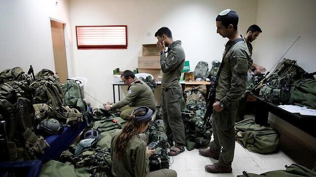 Troops prepare their combat gear