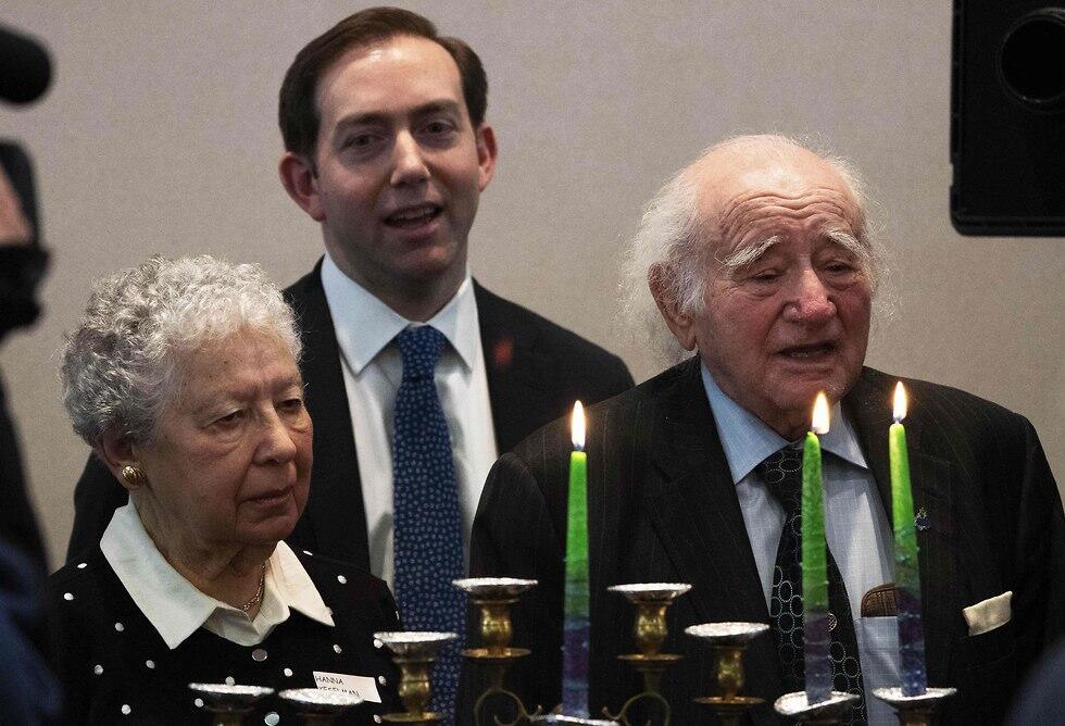 Holocaust survivors Roman Kent, right, and Hanna Keselman take part in a menorah lighting during the International Holocaust Survivors Night. (Photo: AFP) Holocaust survivors Roman Kent, right, and Hanna Keselman take part in a menorah lighting during the International Holocaust Survivors Night.
