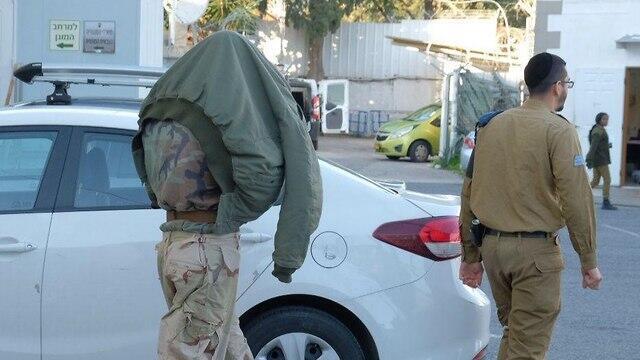 One of the soldiers being brought into court