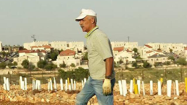 Rizq Salah working in the fields near Netiv Ha’avot 