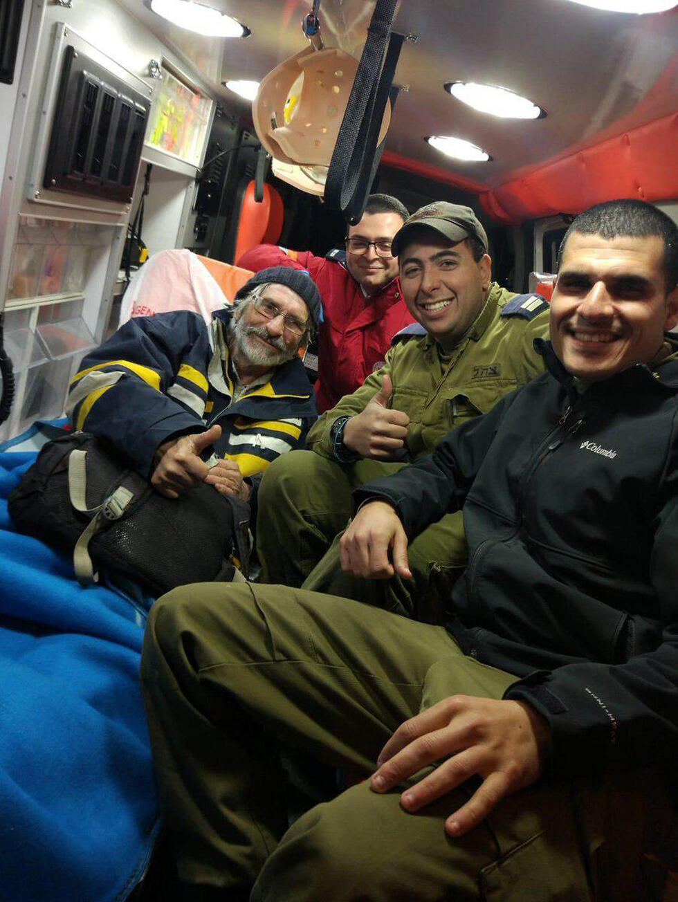 The French sailor being evacuated to the hospital, with the sailors who saved him