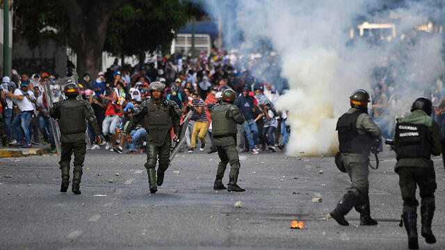 На улицах Каракаса. Фото: AFP (צילום: AFP) На улицах Каракаса. Фото: AFP