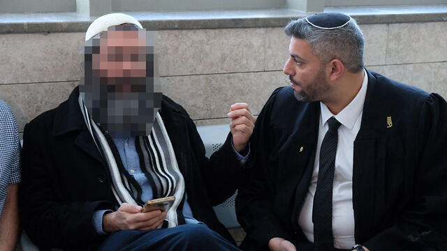 The suspect's father, left, with the suspect's lawyer Amir Bracha