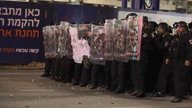 Riot police facing the protesters