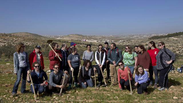 American rabbinical students take a group photo, with the village of Attuwani in the background, during a day planting olive trees, near Hebron in the West Bank (Photo: AP) American rabbinical students take a group photo, with the village of Attuwani in the background, during a day planting olive trees, near Hebron in the West Bank