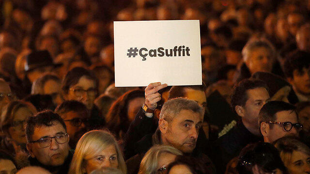 Protest against anti-Semitism in Paris. The poster reads: That's enough (Photo: AP) (צילום: AP) Protest against anti-Semitism in Paris. The poster reads: That's enough (Photo: AP)