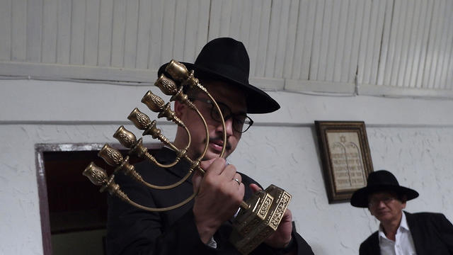 Rabbi Yaakov Baruch holding a menorah at a synagogue in Tondano, North Sulawesi, March 4, 2019 