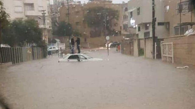 Car stuck in floods in Tayibenullnull Car stuck in floods in Tayibe