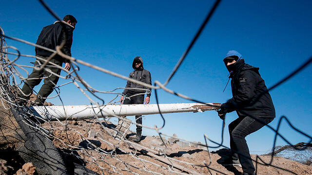 Palestinians clear the damage done by latest IDF strike in Gaza