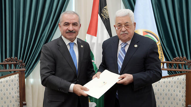 Palestinian President Mahmoud Abbas, right, and Palestinian Prime Minister Mohammad Shtayyeh