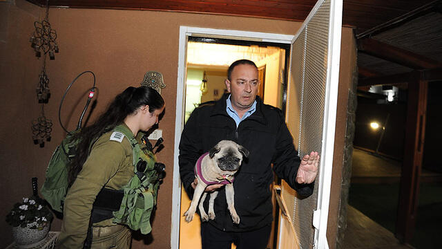 Dog being rescued from the damaged house