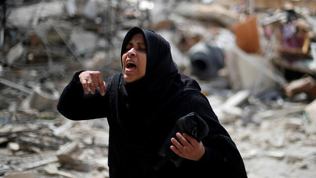 A Palestinian woman amid the rubble in the Gaza Strip after IAF strikes on Hamas targets (Photo: Reuters)