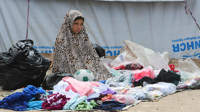 A Syrian girl sells second hand items in the Al-Hol camp for displaced people in northeastern Syria on March 28, 2019 (Photo: AFP) A Syrian girl sells second hand items in the Al-Hol camp for displaced people in northeastern Syria on March 28, 2019