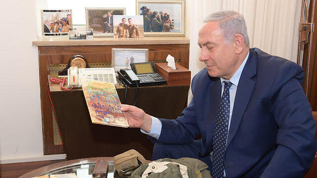 Benjamin Netanyahu holds a Haggadah possibly owned by his brother