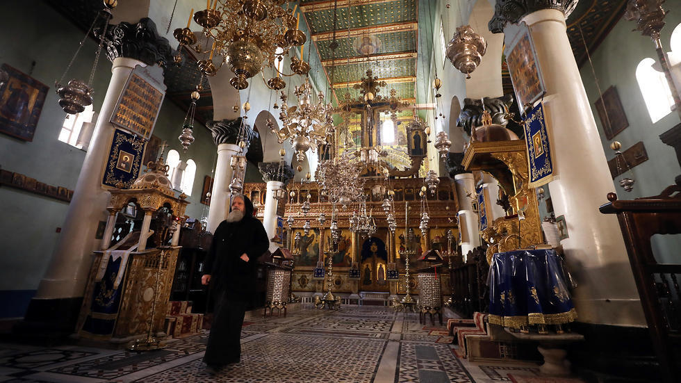 A monk walks inside the basilica of St Catherine's Monastery