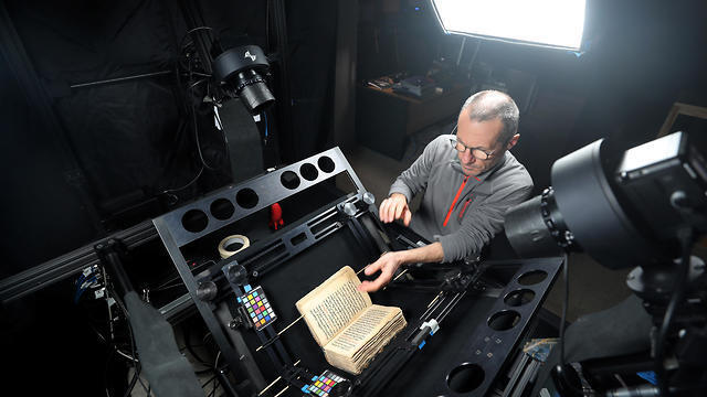 A man photographs ancient manuscript as part of a digitization process in St Catherine's Monastery