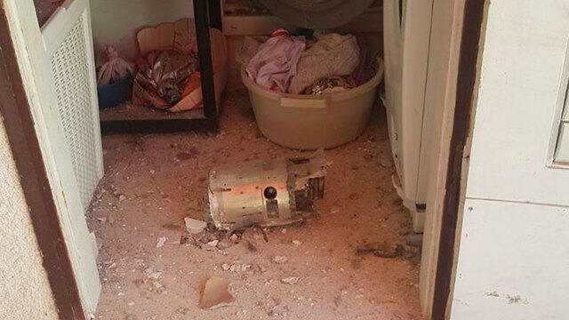 A fragment from an Iron Dome anti-missile battery falls on warehouse near Ashkelon