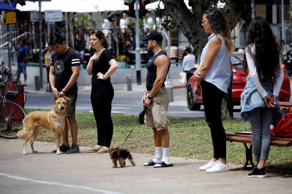 People in Tel Aviv standing still for Memorial Day siren (Photo: Reuters)