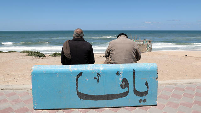 Mahmoud Al-Assi, 73, who said that he was expelled with his family from Jafa, sits on a concrete bench adorned with a word reading "Jaffa", on a beach in Gaza City (Photos: Reuters) Mahmoud Al-Assi, 73, who said that he was expelled with his family from Jafa, sits on a concrete bench adorned with a word reading "Jaffa", on a beach in Gaza City
