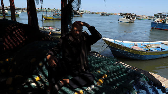 Palestinian fisherman Mahmoud Al-Assi, 73, who said that he was expelled with his family from Jafa when Israel was founded in 1948, sits at the seaport of Gaza City (Photos: Reuters) Palestinian fisherman Mahmoud Al-Assi, 73, who said that he was expelled with his family from Jafa when Israel was founded in 1948, sits at the seaport of Gaza City