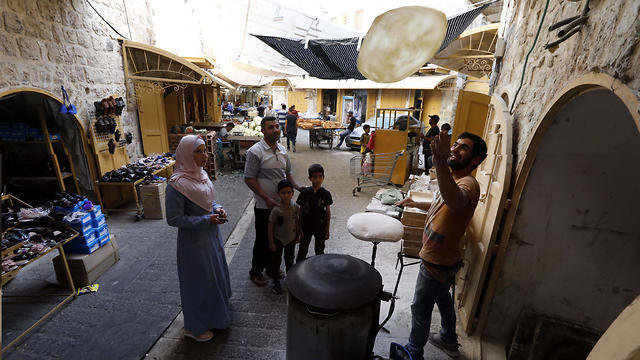 Palestinian baker prepares 'shrak' a traditional bread sold during Ramadan in Hebron