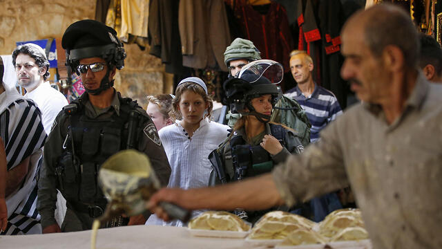 Border Police troops guarding settlers in the new market in Hebron