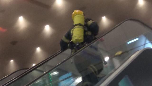 A firefighter makes his way towards a blaze at Ayalon Mall in Ramat Gan on Tuesday