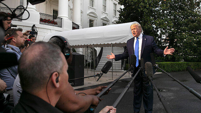 U.S. President Donald Trump speaks to reporters as he prepares to head to Europe Sunday (צילום: AP) U.S. President Donald Trump speaks to reporters as he prepares to head to Europe Sunday