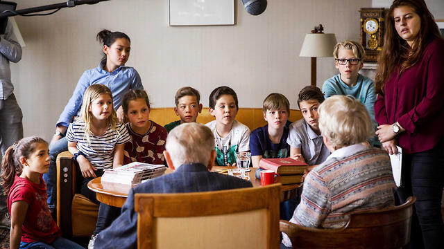 Albert Gomes de Mesquita and Jacqueline van Maarsen talk to students of the Anne Frank Montessori school on the famed Holocaust diarist's 90th birthday in her former home in Amsterdam, June 12, 2019
