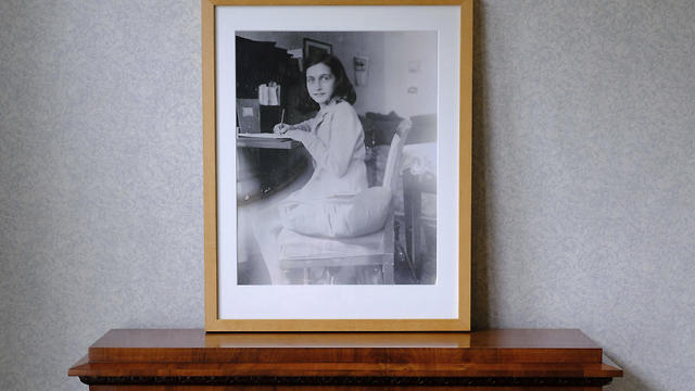A photo of Anne Frank stands on a replica of the writing desk she once used in her family's former apartment in Amsterdam, during an event to mark what would have been her 90th birthday, in Amsterdam, June 12, 2019