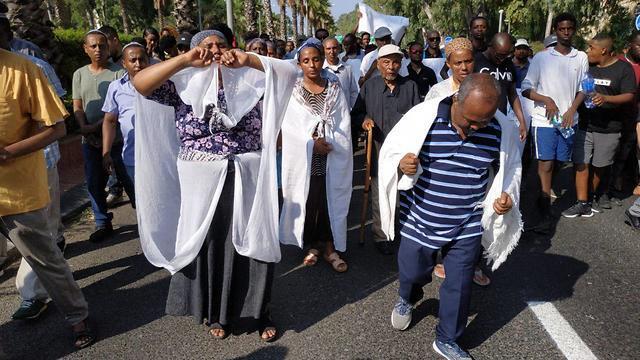 The parents of Solomon Tekah lead his funeral procession in Haifa