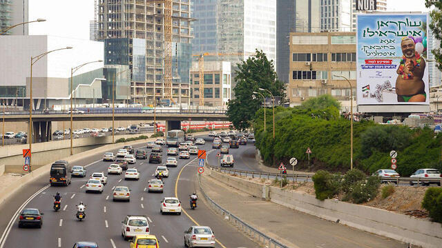 The controversial billboard overlooks the Ayalon Highway
