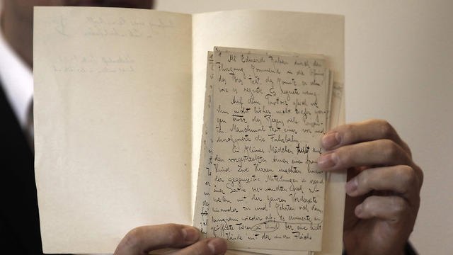 National Library archival expert and Humanities Collection Curator Stefan Litt reveals a a manuscripts by novelist Franz Kafka, during a press conference at the National Library of Israel in Jerusalem on August 7, 2019