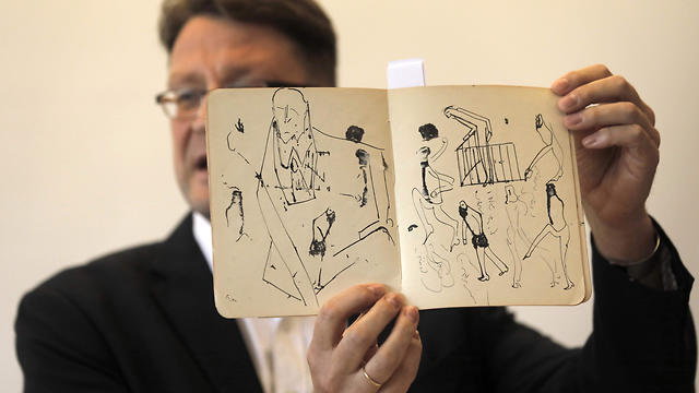 National Library archival expert and Humanities Collection Curator Stefan Litt reveals a a manuscripts by novelist Franz Kafka, during a press conference at the National Library of Israel 