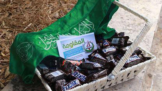 Palestinians hand out candies in celebration of the killingnullnull Palestinians hand out candies in celebration of the killing