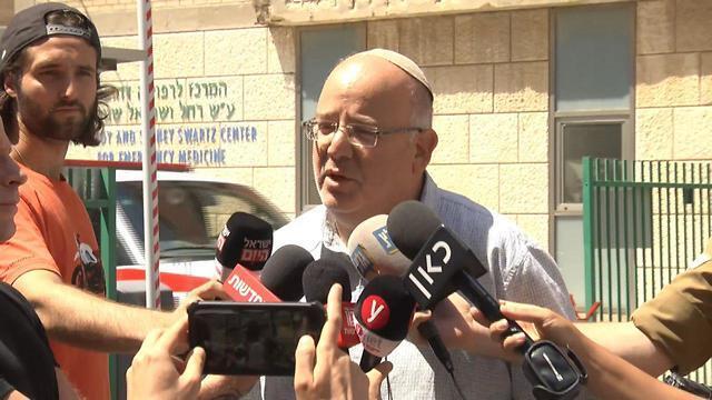 Rina Shnerb's uncle Shmulik Shenhav talks to reporters at the Jerusalem hospital where the victims were being treated (צילום: שמוליק דודפור) Rina Shnerb's uncle Shmulik Shenhav talks to reporters at the Jerusalem hospital where the victims were being treated