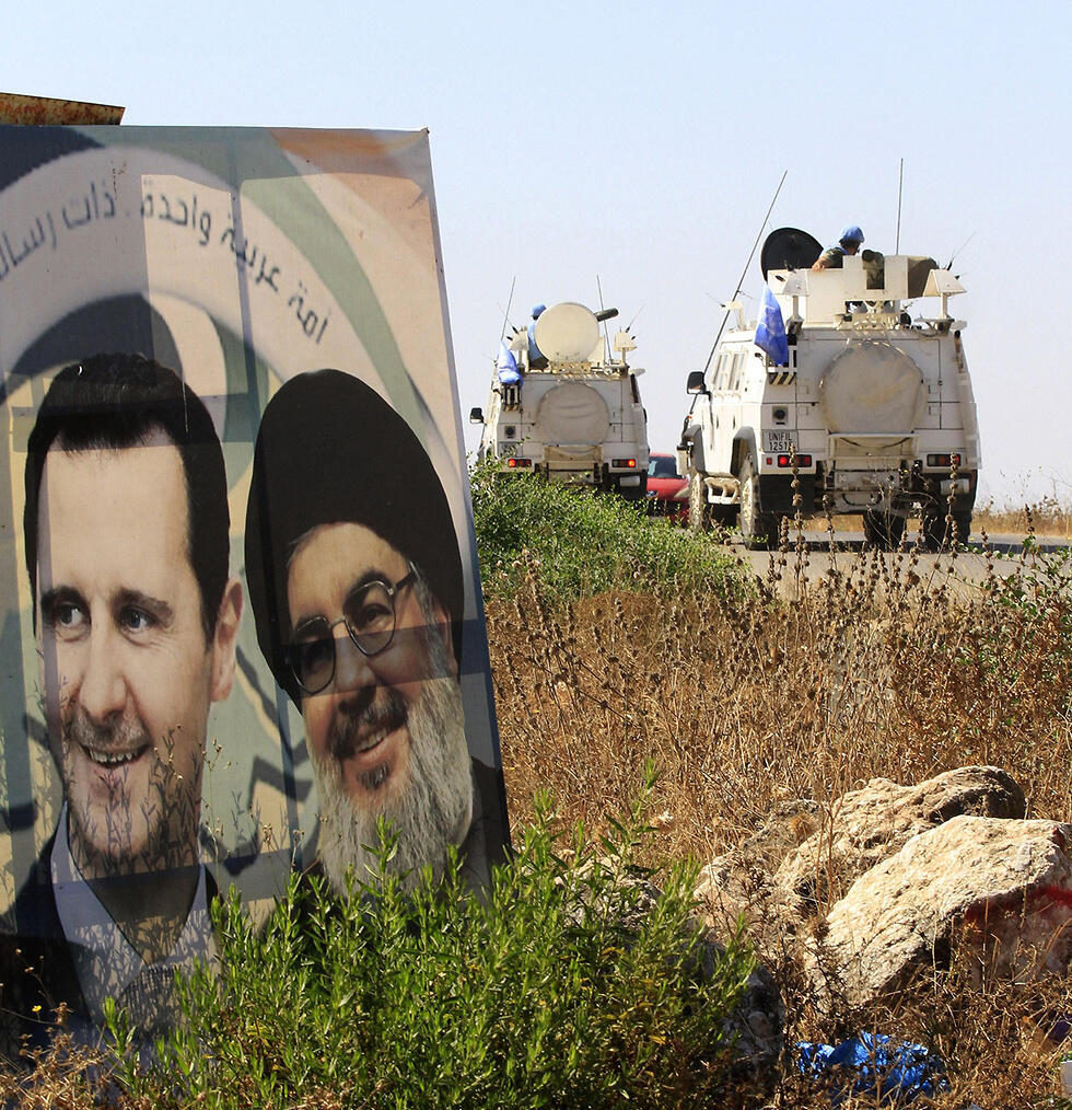 UN peacekeepers in south Lebanon drive past a poster of Hezbollah chief Hassan Nasrallah and Syrian President Bashar Assad (צילום: AFP) UN peacekeepers in south Lebanon drive past a poster of Hezbollah chief Hassan Nasrallah and Syrian President Bashar Assad