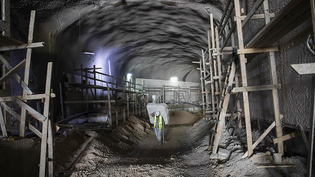 A worker walks at the construction site of a massive underground cemetery in Jerusalem, August 18, 2019 (Photo: AP) A worker walks at the construction site of a massive underground cemetery in Jerusalem, August 18, 2019