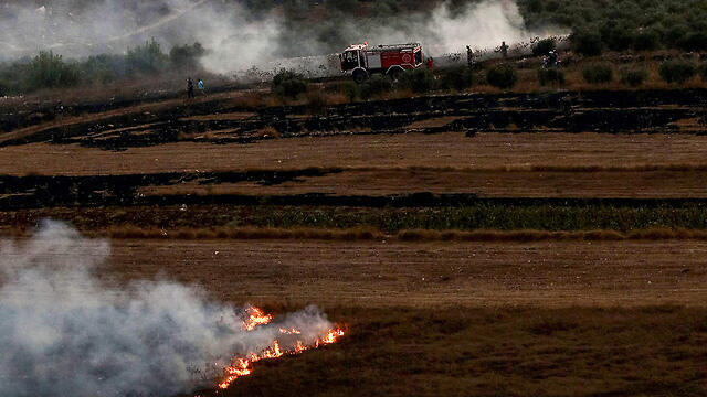 A Lebanese fire truck douses flames after IDF artillery fire on southern Lebanon