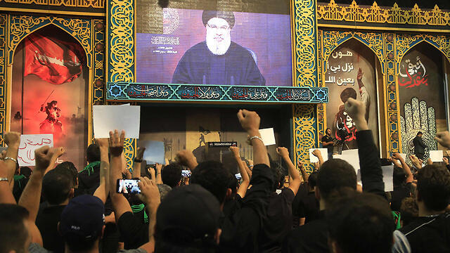 Hezbollah supporters watching Hassan Nasrallah's speech televised from Beirut on Monday