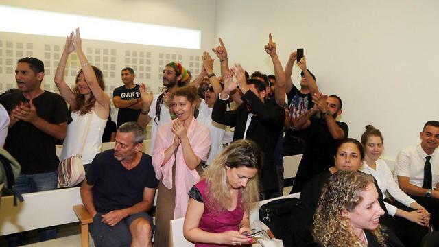 Amos Dov Silver is greeted with applause in court Monday